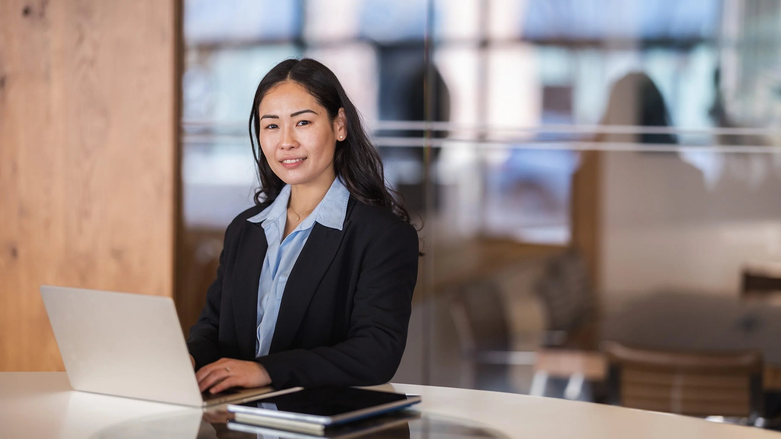Professional seated at a desk with a laptop
